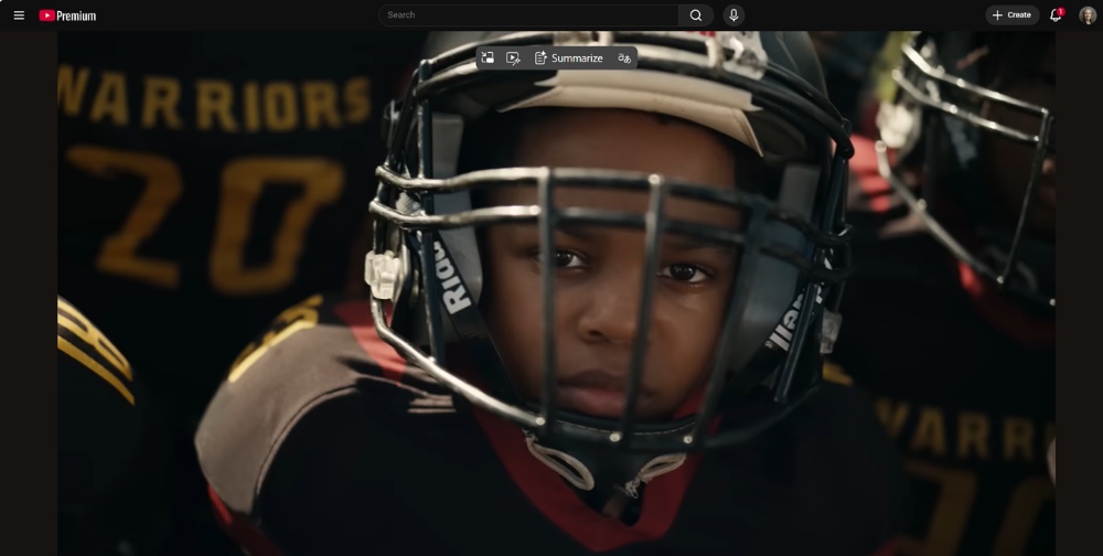 Young boy in a football jersey and helmet.